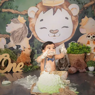 Hakuna Matata. This little one is having a wild time at his jungle-themed first birthday cake smash, surrounded by his favorite animal friends.