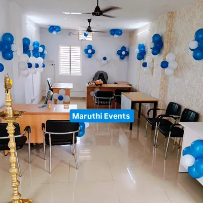 A professional and clean decoration for an office inauguration. This setup uses blue and white balloon clusters to add a festive touch without being overwhelming.