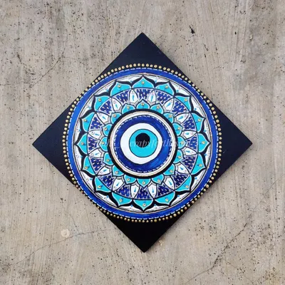 My take on the 'Nazar' or evil eye, designed as a mandala. I used shades of blue and white with gold accents to create this protective and beautiful wall hanging.