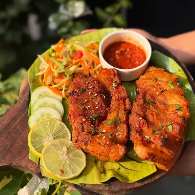 Our Crispy Pork Belly is back on the menu by popular demand. Each piece is fried until golden and served on a banana leaf with a fresh salad and a spicy dipping sauce made with Raja Mircha.