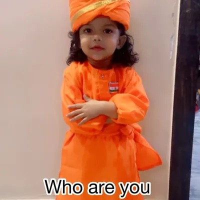 A young child dressed as Swami Vivekananda, a popular choice for school events celebrating national heroes. The costume includes the iconic orange robes and turban.