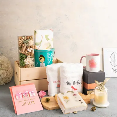 This "Ms. Perfect" pamper hamper is a wonderful gift for the bride. It includes personalized towels, a scented candle, artisanal soap, and other spa essentials packed in a rustic wooden crate.