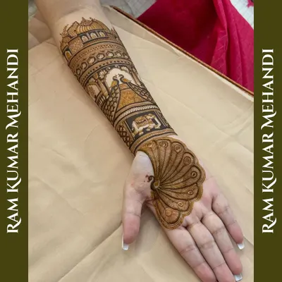 A unique design where the peacock's feather transforms into the full palm design. The arm features a traditional palace scene, creating a truly artistic piece.