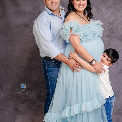 Including older siblings in a maternity shoot makes for the most heartwarming family portraits. This image perfectly captures the excitement of a growing family, with everyone sharing a hug around the baby bump.