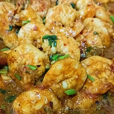 My ready-to-eat shrimp curry, cooked in a flavorful gravy with fresh herbs. The shrimp are tender and absorb all the spices from the sauce.
