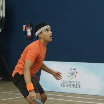 A young player tracks the shuttlecock with intense focus during the Yonex Sunrise Gautam Thakkar Memorial Championship. Our events provide a platform for serious junior competitors to shine.
