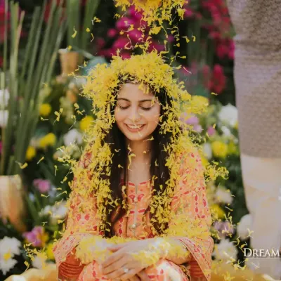 A bride showered in a cascade of marigold petals during her Haldi. I love creating these moments of pure, unscripted joy, set against a backdrop of abundant, traditional florals.