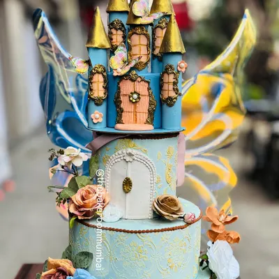 This enchanting blue castle cake is a true fairytale creation, complete with kinetic butterfly wings that seem to flutter. The intricate details and golden turrets make it a magical centerpiece.