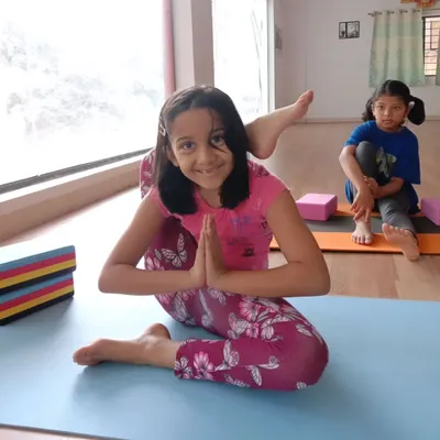 Look at that smile. This young yogi is mastering Eka Pada Sirsasana, or the leg-behind-head pose, with confidence. My goal is to help every child feel proud of their progress, no matter the pose.