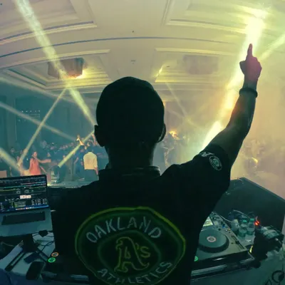 A classic DJ pose from behind the decks, pointing up to the sky. This shot from my March dump captures the feeling of being on top of the world during a great set.
