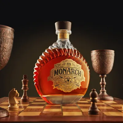 For Monarch brandy, we built a world of strategy and royalty. This conceptual shot places the bottle as the king on a chessboard, surrounded by custom pieces. It’s about creating a narrative of power and legacy, captured entirely in-camera.