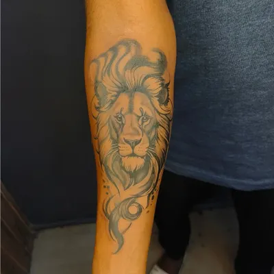 A majestic lion's head on the forearm. The flowing mane and intense gaze were designed to represent courage and leadership.