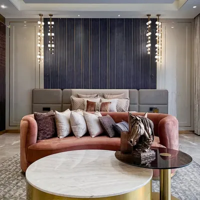 We designed this master bedroom to feel both lived-in and elevated. The fluted, graphite-toned wall serves as a dramatic backdrop for the bed, while a custom curved sofa in a blush fabric adds a soft, inviting touch at the foot.