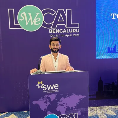 Hosting the We Local Bengaluru conference, a major event for the Society of Women Engineers. My job at the podium is to guide the audience through the agenda with clarity and energy.