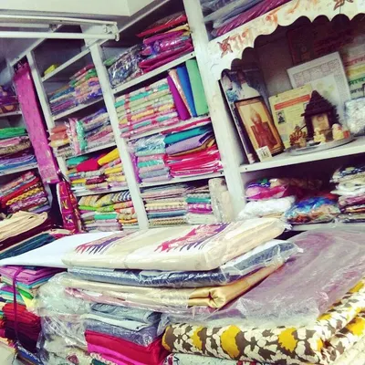 A view of our workshop shelves, stocked with a wide variety of colorful fabrics. You can bring your own material or choose from our collection.