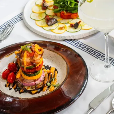 A tower of slow-roasted garden vegetables, a dish that is both healthy and full of earthy, rustic flavor, inspired by the fields of Andalusia.