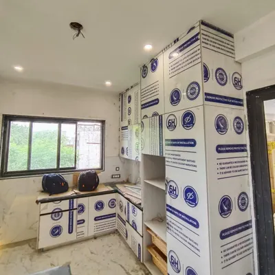 An ongoing installation in Gurgaon. This image shows the kitchen cabinets with their protective film still on, ensuring the high-gloss Italian acrylic shutters remain scratch-free until the final handover.