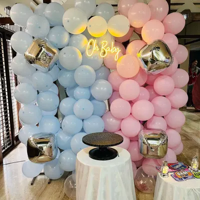 This is my popular 'Oh Baby' gender reveal backdrop. It features a wall of pastel pink and blue balloons, shiny silver cube foil balloons, and a central neon sign that creates a beautiful focal point for photos.