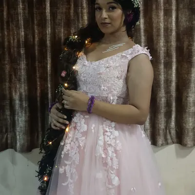 Feel like Rapunzel in this whimsical pink gown, complete with a long, decorated braid. A perfect rental for a fairytale-themed maternity or pre-wedding shoot.