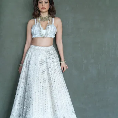 I styled Nushrratt Bharuccha in this ethereal ivory lehenga by Disha Patil for a wedding. The layered pearl necklaces add a touch of modern royalty, making it a standout look for a wedding guest.