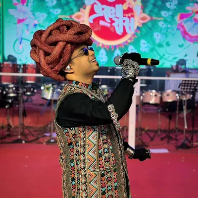 It's not just the outfit, but how you carry it. Sporting a traditional Rajasthani turban and an embroidered vest for a Navratri event, ready to bring the festive energy.