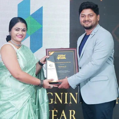 Our founder Haricharan K V accepting the 'Creative Designing Firm of the Year' award on stage. This recognition fuels our passion for delivering exceptional design solutions to every client.