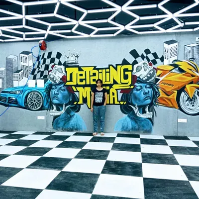 The finished graffiti mural for The Detailing Mafia, a luxury car garage. This huge 27-foot piece has a sporty, edgy theme and completely transforms the look of the workshop.