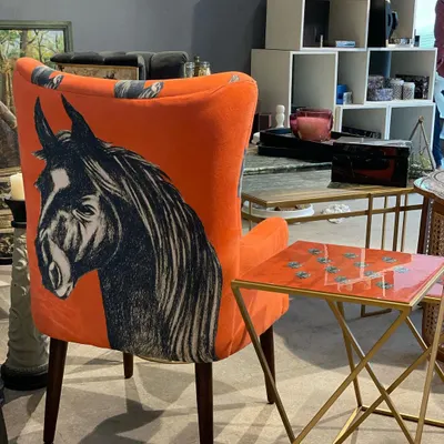 The Stallion Chair, seen here in my studio, is a signature piece from the collection. The contrast between the bright orange and the monochrome horse print creates a bold accent piece that brings energy to any room.