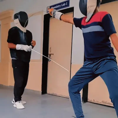 Two of our fencers engaged in a practice bout during our summer camp. We create a competitive yet supportive environment for students to hone their épée and foil techniques.