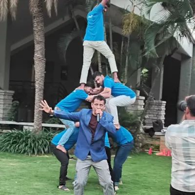A powerful moment from an outdoor team building session where the team created a human pyramid. This activity is designed to build physical support, trust, and a shared sense of accomplishment.