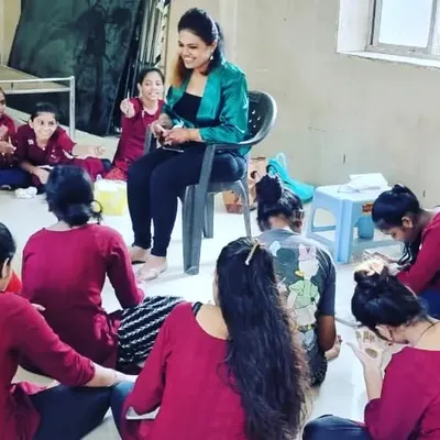 This is what my hands-on workshops look like. I believe in giving personal attention to each student, guiding them as they practice their strokes and build their confidence. Here I am mentoring students at a workshop for an NGO.