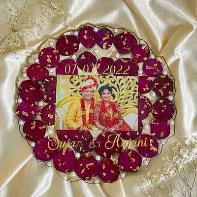 This custom 10-inch photo frame is one of my most popular wedding services. I carefully arrange petals from your varmala or bouquet around your favorite photo, adding names and your wedding date to make it a true family heirloom.