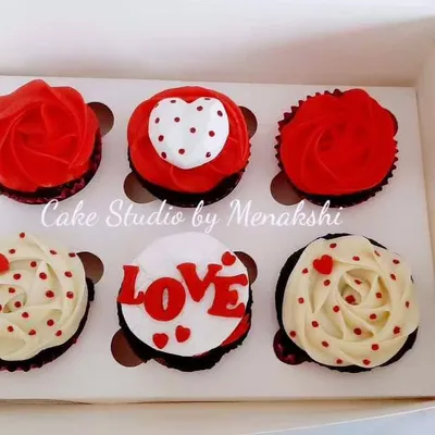 Cupcakes made for your loved ones. This box of red velvet cupcakes is decorated with red and white frosting, hearts, and the word "LOVE," perfect for an anniversary or Valentine's Day.