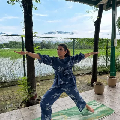 Here I am in the Warrior II pose, feeling grounded and expansive with the mountains and paddy fields as my witness. My retreats are all about finding these moments of connection between your body, your breath, and the incredible nature around us.