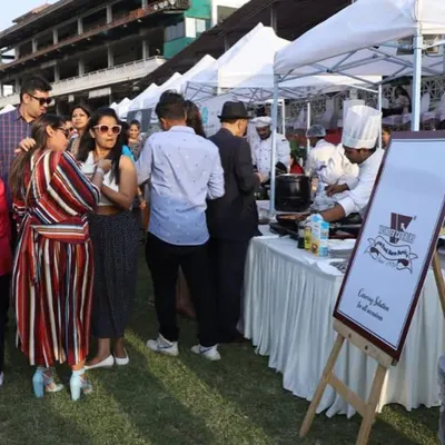 We were proud to cater an event in the VIP lounge at the Mahalaxmi Racecourse. This image shows guests enjoying the food from our live counters on a beautiful sunny day.