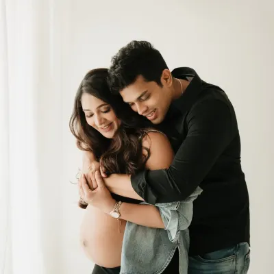 A warm, happy embrace. This is the kind of candid moment I love to capture in a casual couples maternity shoot. It’s all about your genuine connection.