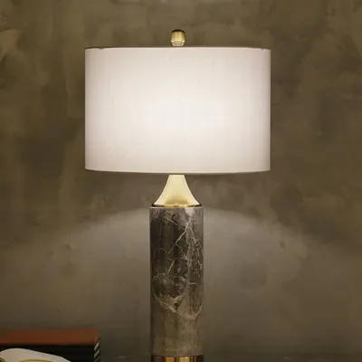 This Mabbina table lamp is built around a pillar of genuine marble, giving it a substantial and luxurious feel. It's a mid-century modern design that brings an element of timeless, natural elegance to any surface.