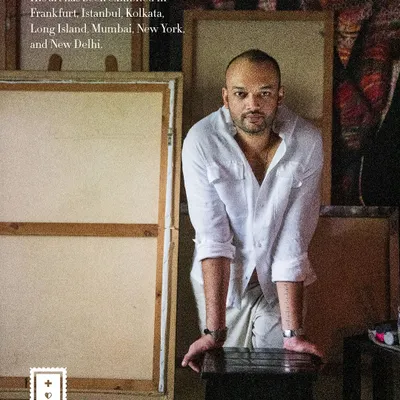 A portrait of artist Pushkar Thakur in his creative space. The text overlay shares a piece of his story, and the image captures his focused intensity, surrounded by his canvases.