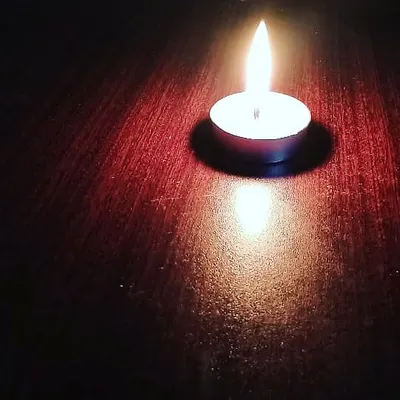 A single lit tealight, showing its bright and steady flame. I ensure every tealight burns for at least 1.5 to 2 hours, making them a reliable choice for bulk use in restaurants and for events.