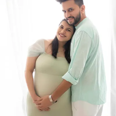 A bright and joyful couple's portrait. Her head resting on his shoulder, this image is filled with the easy, comfortable love between them.