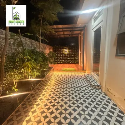 A complete backyard makeover. I designed and executed the entire project, including the patterned tile flooring, integrated lighting, vertical garden, and real plants.