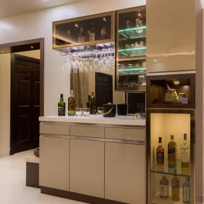 A stylish bar and crockery unit design. This piece features glass-front cabinets with integrated lighting, a wine glass rack, and a marble countertop for serving.