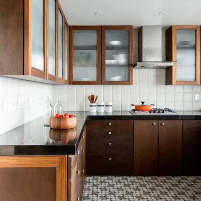 The kitchen in the Terrazzo Residence combines the warmth of wood with the graphic pattern of cement floor tiles. We used frosted glass on the upper cabinets to lighten the space and provide semi-concealed storage.