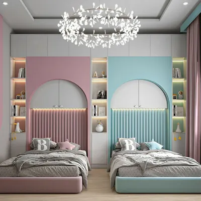 We designed this beautiful shared bedroom with a symmetrical layout to create a sense of harmony and personal space for two children. The design features custom arched headboards with fluted paneling, integrated shelving with ambient LED lighting, and a distinct color palette for each side, blending modern aesthetics with child-friendly personalization.