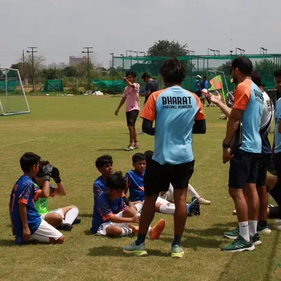 Guiding our young warriors on and off the field. A half time talk is a crucial moment for strategy and motivation.