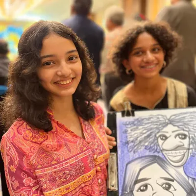 Two young girls with their group caricature at the Sheraton Grand Pune. It's a fun souvenir for friends to share.