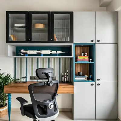 A highly functional study area with floor-to-ceiling cabinets for maximum storage. The design includes a mix of closed and open shelving, with fluted glass doors adding a touch of elegance.