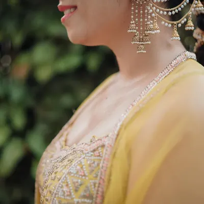 A close-up on the bride's stunning ear cuff, a piece of art in itself. We believe that capturing the details of your bridal jewelry is essential to telling the full story of your look.