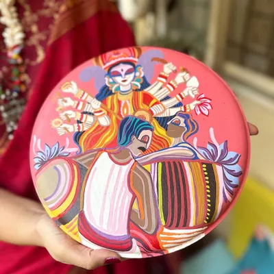 A throwback to a Durga Pujo themed plate we painted for a client. It depicts the goddess Durga along with dhakis, capturing the vibrant energy of the festival.