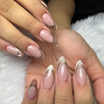 An elegant and modern take on the French manicure. This design features a clean, sheer base with a delicate gold and silver double line defining the tip.